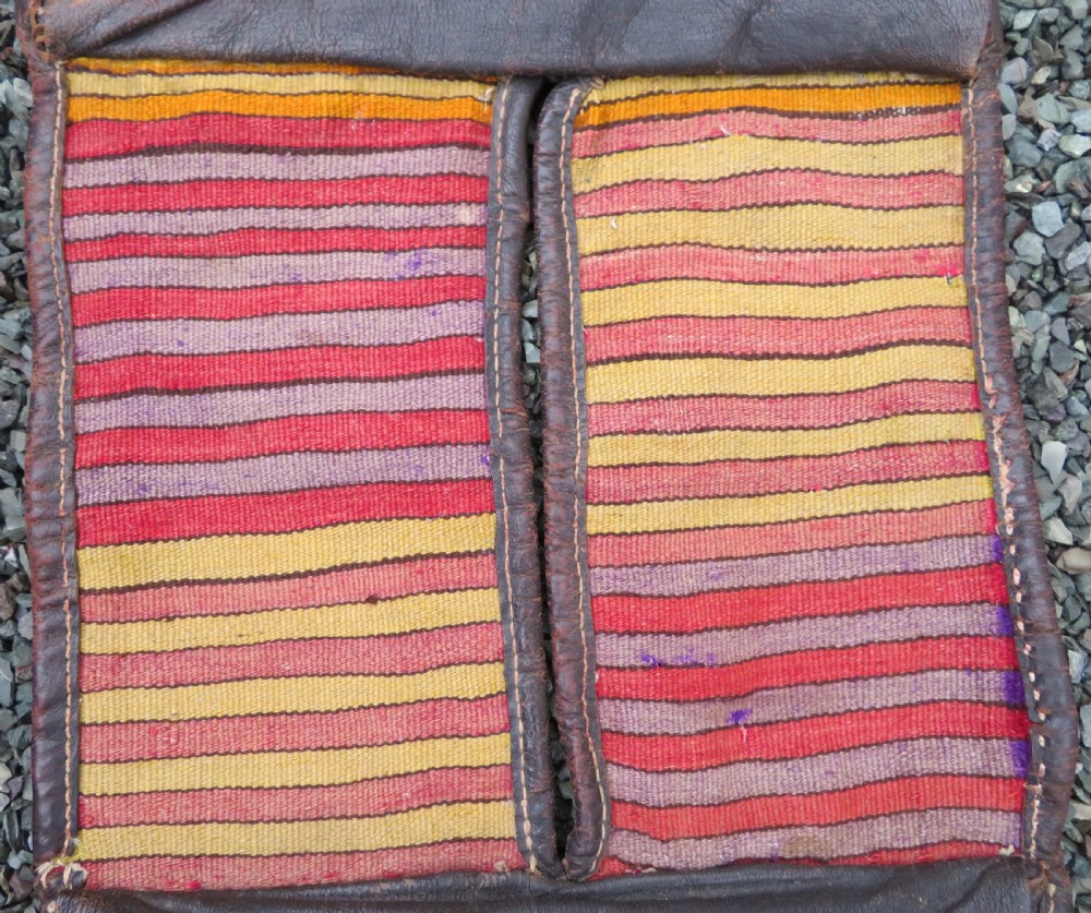 A late 19th-century Shahsavan Persian double saddle bag featuring dark leather flaps and central multi-coloured striped wool flatweave panels. View VIII