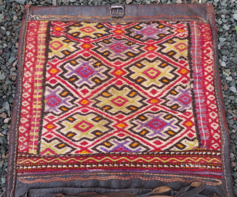 A late 19th-century Shahsavan Persian double saddle bag featuring dark leather flaps and central multi-coloured striped wool flatweave panels. View X