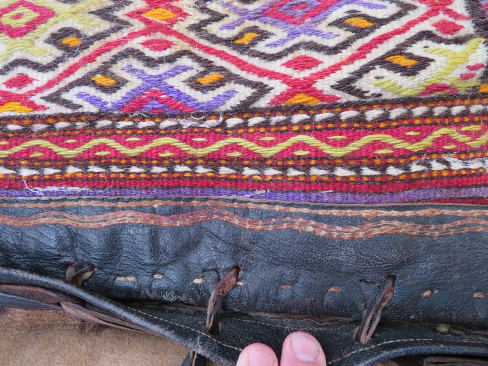 A late 19th-century Shahsavan Persian double saddle bag featuring dark leather flaps and central multi-coloured striped wool flatweave panels. View XI