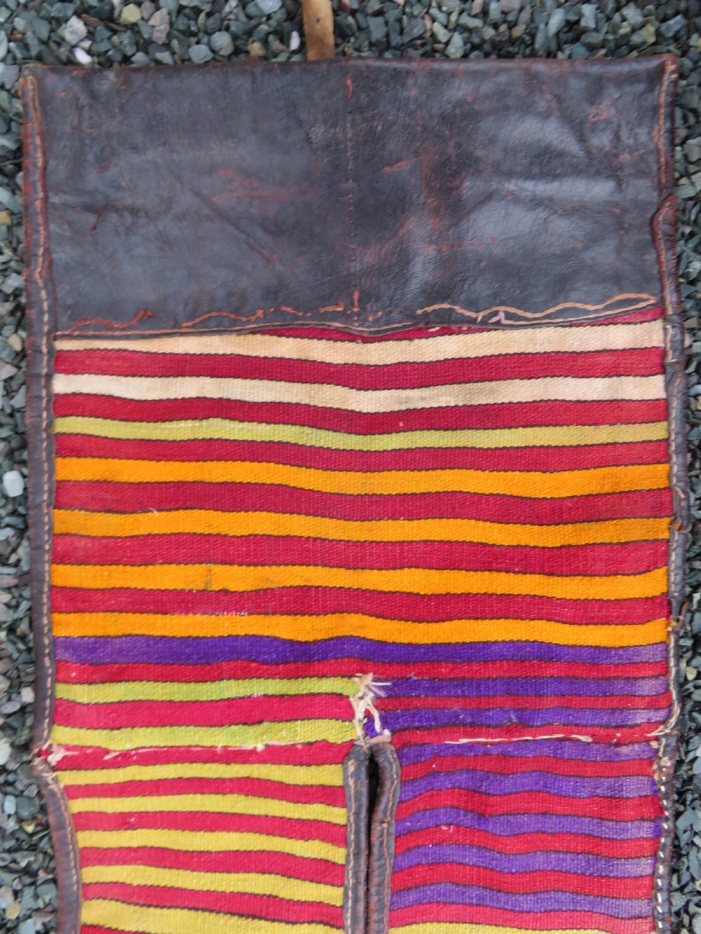 A late 19th-century Shahsavan Persian double saddle bag featuring dark leather flaps and central multi-coloured striped wool flatweave panels. View XIV