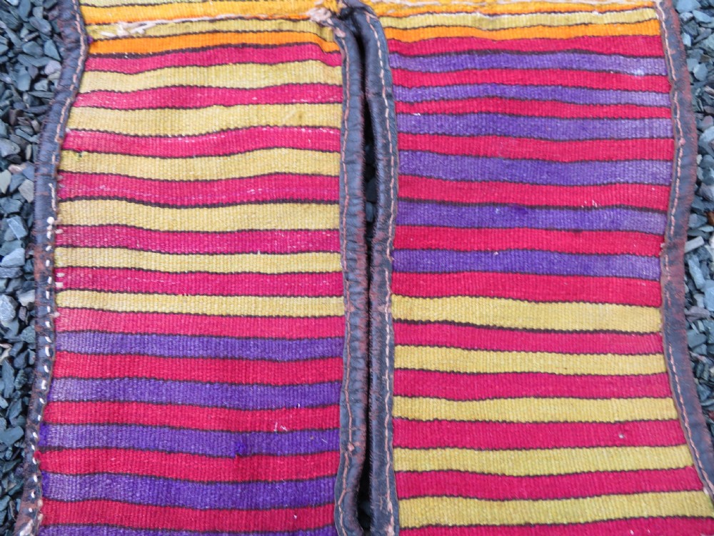 A late 19th-century Shahsavan Persian double saddle bag featuring dark leather flaps and central multi-coloured striped wool flatweave panels. View XV
