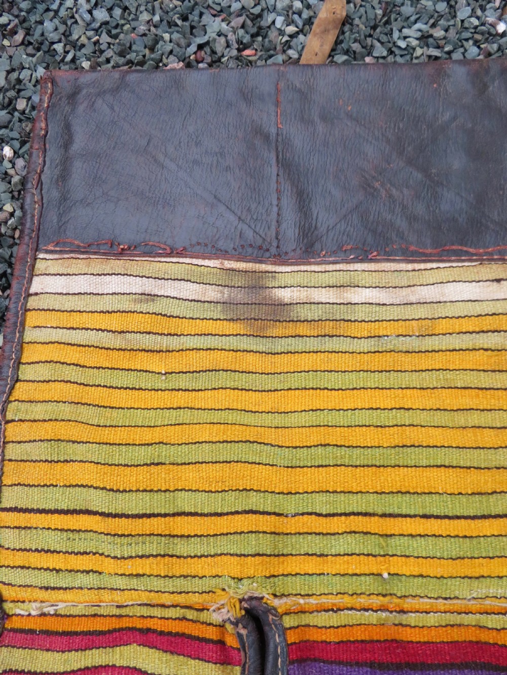 A late 19th-century Shahsavan Persian double saddle bag featuring dark leather flaps and central multi-coloured striped wool flatweave panels. View XVI