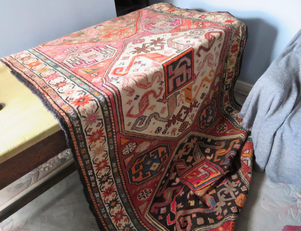 An antique hand-knotted Caucasian Karabagh Chondoresk long runner featuring bold geometric cloudband medallions in shades of red, black, and cream with an ornate decorative border. View XII