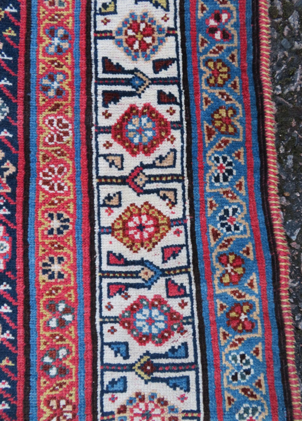 An antique hand-knotted Qashqai Kashkuli wool rug featuring three stacked diamond medallions in red, indigo blue, and ivory surrounded by intricate geometric borders. View XIII