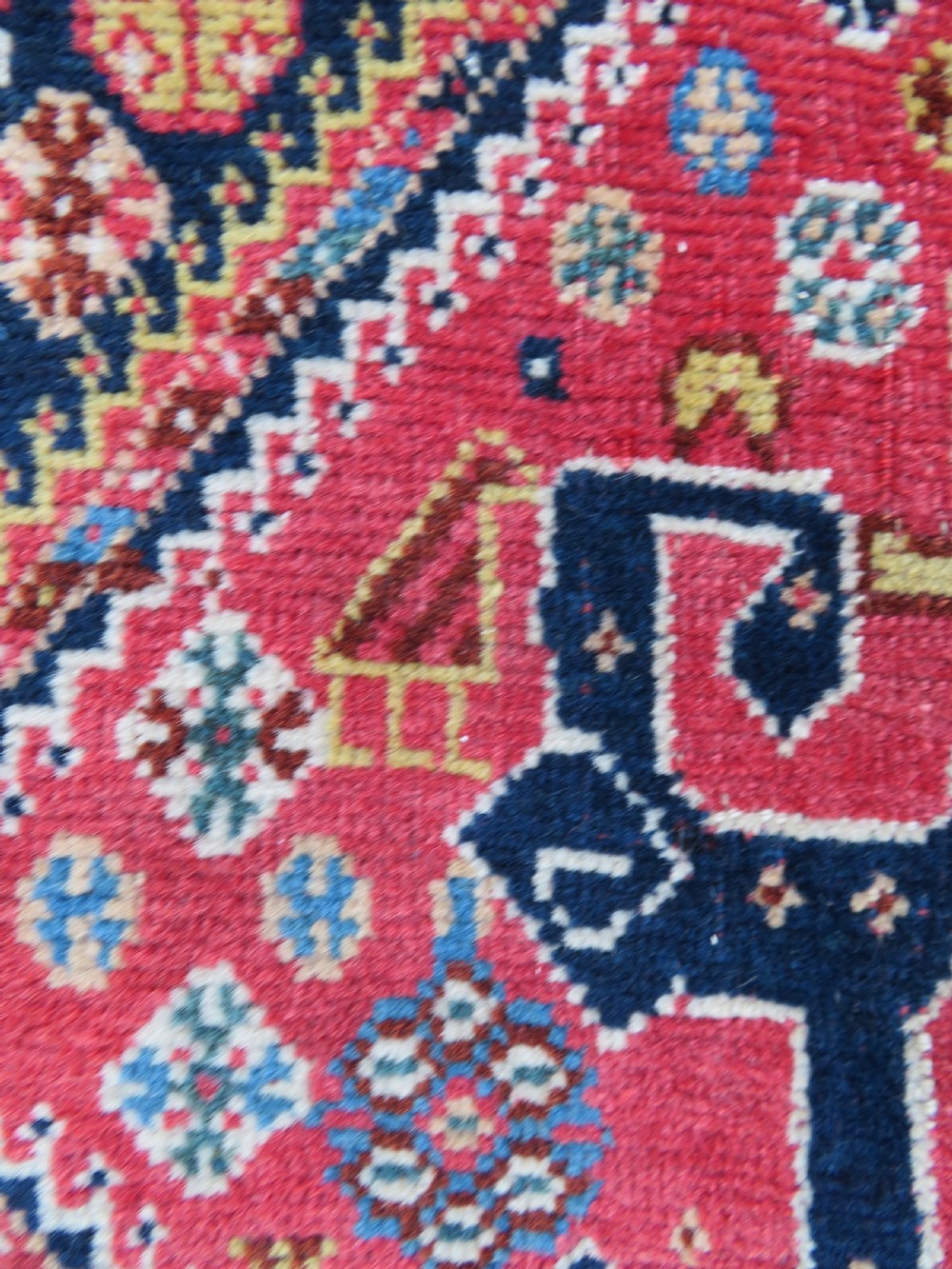 An antique hand-knotted Qashqai Kashkuli wool rug featuring three stacked diamond medallions in red, indigo blue, and ivory surrounded by intricate geometric borders. View XX