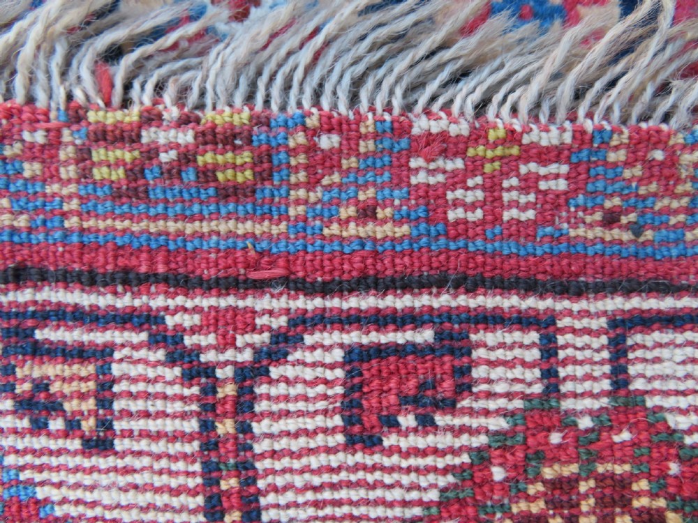 An antique hand-knotted Qashqai Kashkuli wool rug featuring three stacked diamond medallions in red, indigo blue, and ivory surrounded by intricate geometric borders. View XXV