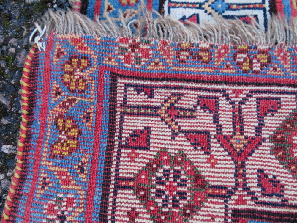 An antique hand-knotted Qashqai Kashkuli wool rug featuring three stacked diamond medallions in red, indigo blue, and ivory surrounded by intricate geometric borders. View XXVII