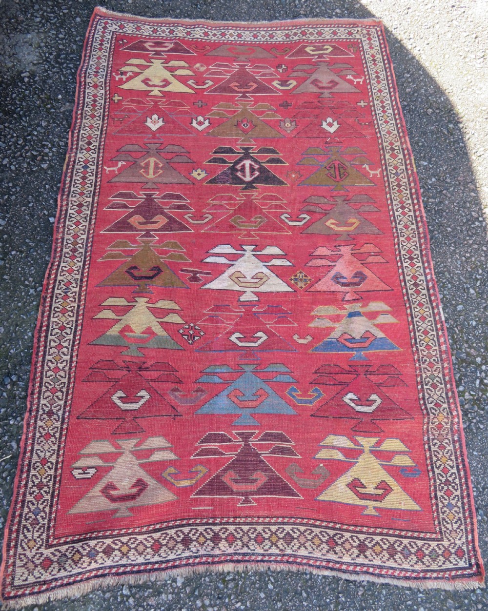 An antique South Caucasian Karabagh hand-knotted wool rug with repeating geometric motifs across a deep red field and a patterned border. View XIX