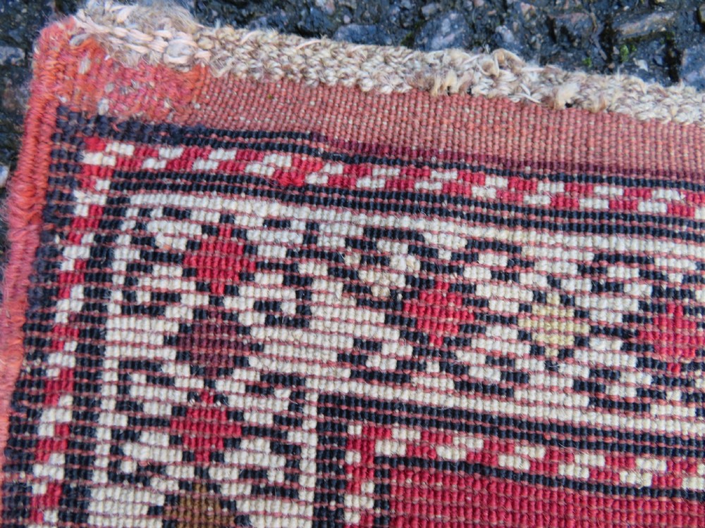 An antique South Caucasian Karabagh hand-knotted wool rug with repeating geometric motifs across a deep red field and a patterned border. View XXII