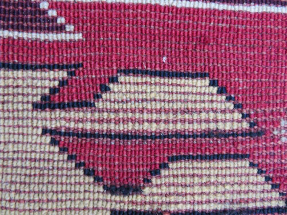 An antique South Caucasian Karabagh hand-knotted wool rug with repeating geometric motifs across a deep red field and a patterned border. View XXIII