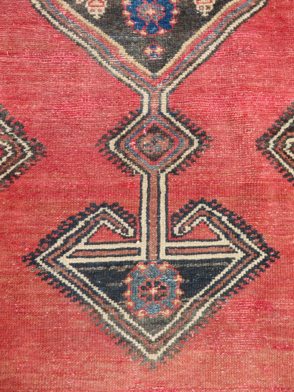 An antique Northwest Persian Zanjan Kelleh rug featuring a red field with diamond medallions surrounded by a wide cream, blue, and red Harshang crab border. View XIII