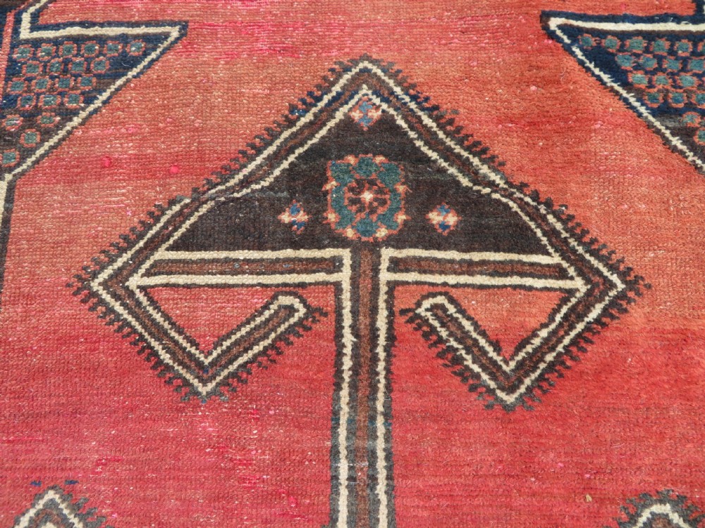 An antique Northwest Persian Zanjan Kelleh rug featuring a red field with diamond medallions surrounded by a wide cream, blue, and red Harshang crab border. View XV