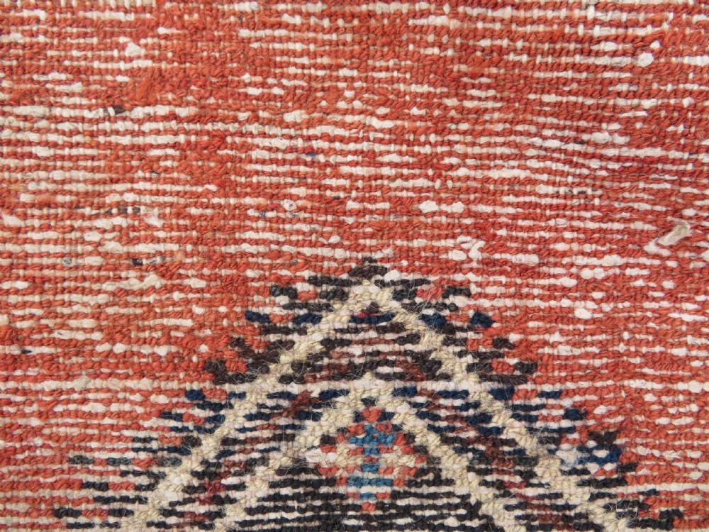 An antique Northwest Persian Zanjan Kelleh rug featuring a red field with diamond medallions surrounded by a wide cream, blue, and red Harshang crab border. View XIX