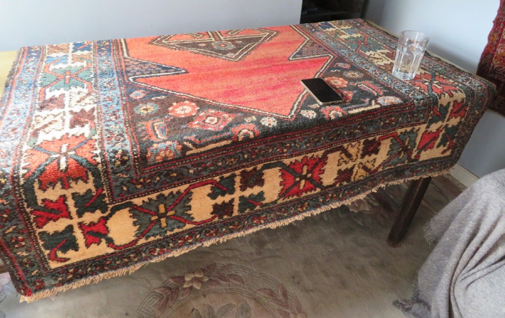 An antique Northwest Persian Zanjan Kelleh rug featuring a red field with diamond medallions surrounded by a wide cream, blue, and red Harshang crab border. View XX