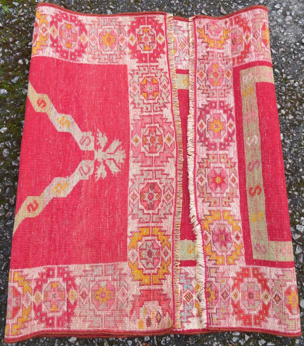 A 19th-century hand-woven Turkish Konya prayer rug featuring a bold crimson red field with a stepped arch niche and geometric borders in yellow, pink, and cream. View VIII