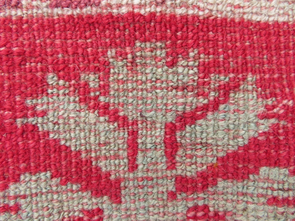 A 19th-century hand-woven Turkish Konya prayer rug featuring a bold crimson red field with a stepped arch niche and geometric borders in yellow, pink, and cream. View XI