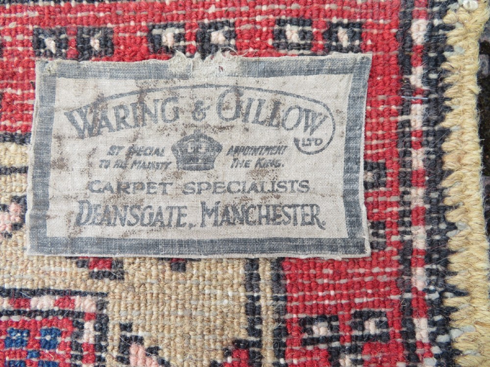 A long hand-knotted Persian Heriz runner rug featuring central geometric medallions in terracotta red and navy blue bordered by intricate geometric patterns. View XIII