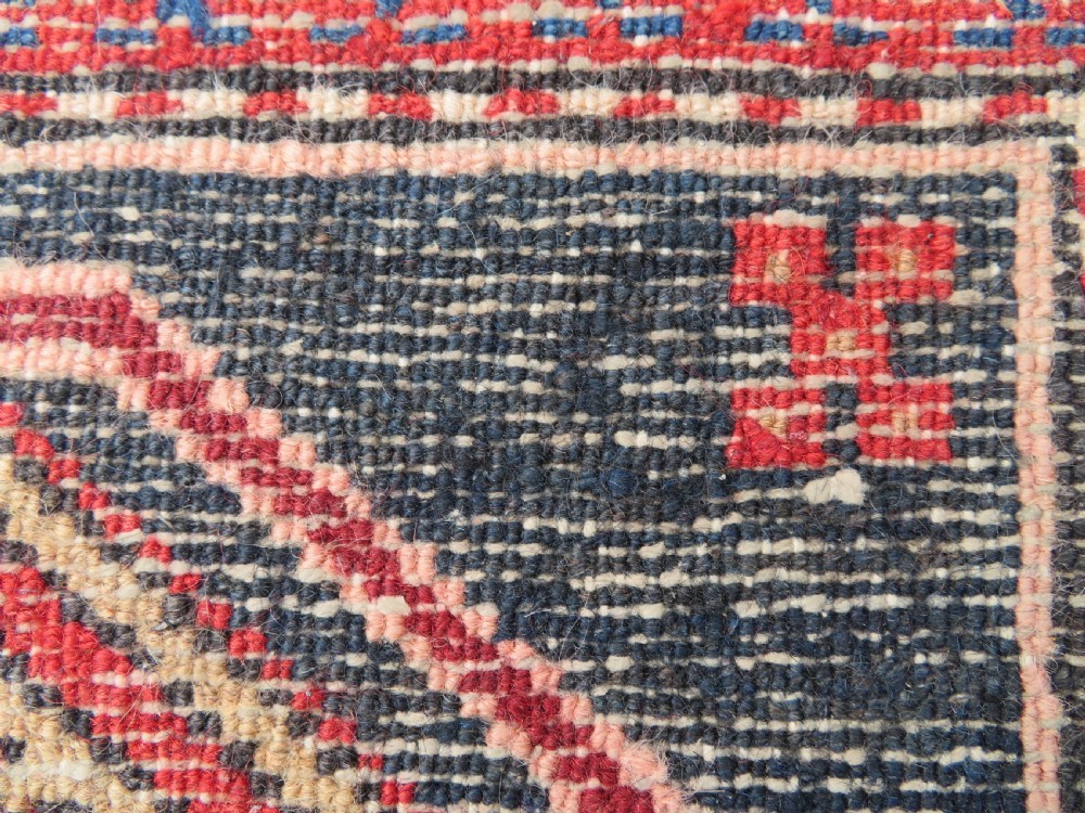 A long hand-knotted Persian Heriz runner rug featuring central geometric medallions in terracotta red and navy blue bordered by intricate geometric patterns. View XIV