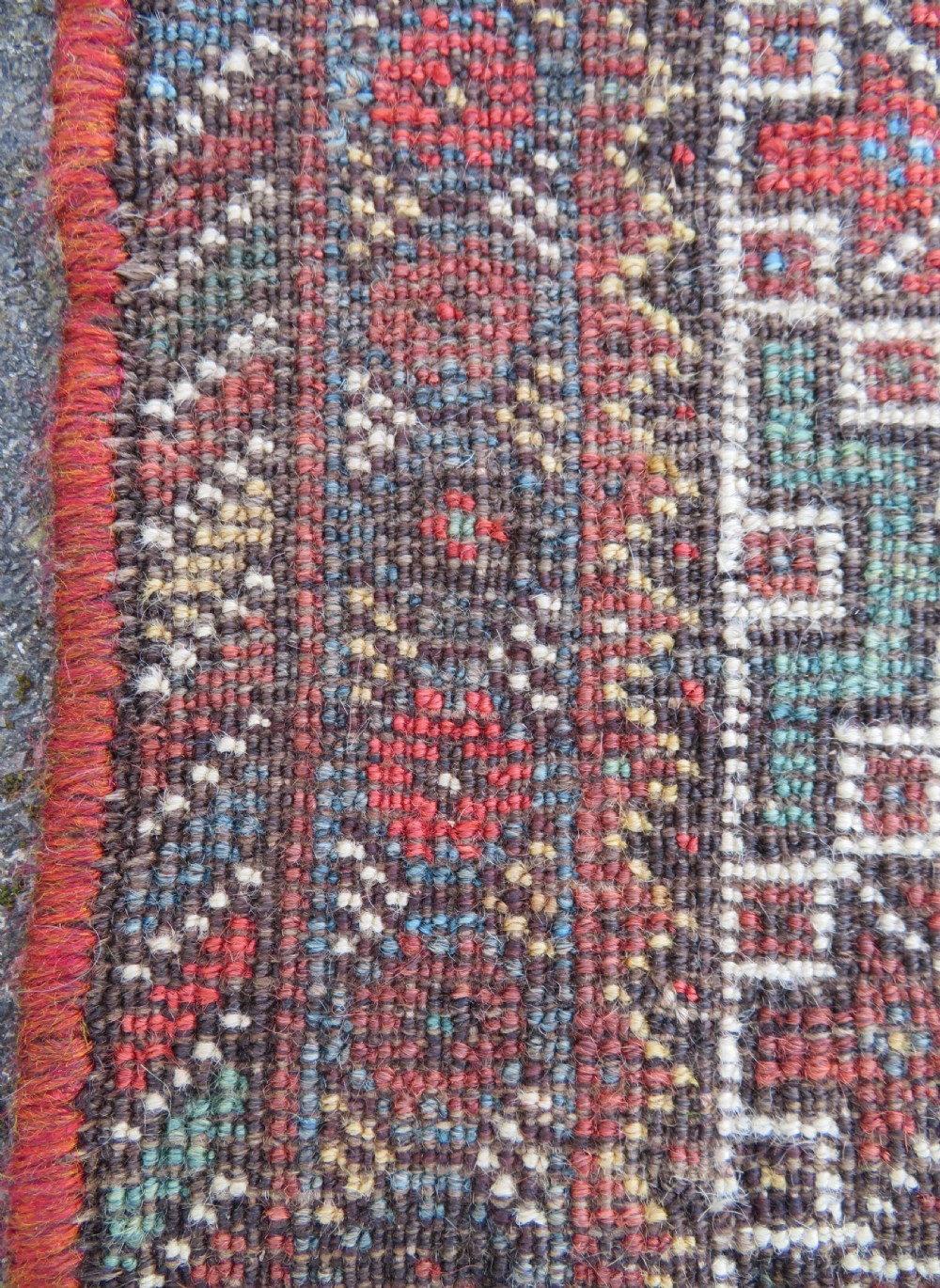 A rectangular hand-knotted antique Khamseh wool rug featuring geometric diamond medallions and intricate border patterns in terracotta, dark brown, and cream. View XXI