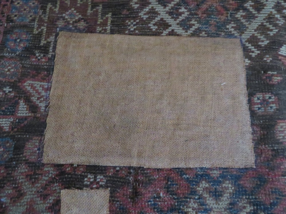 An antique hand-knotted wool runner rug featuring repeating geometric diamond medallions down a central dark field with multi-tiered tribal borders. View XXV