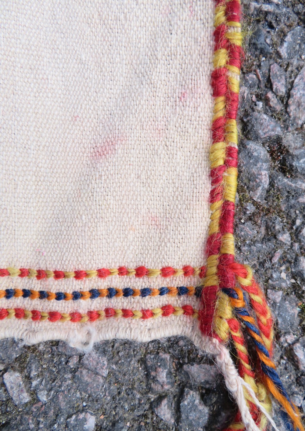 An antique cream handwoven wool Qashqai horse cover featuring colourful geometric patterns, human and camel motifs, and decorative edge tassels. View XX