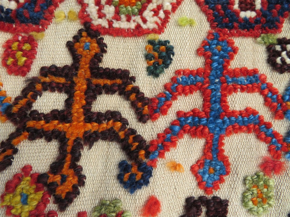An antique cream handwoven wool Qashqai horse cover featuring colourful geometric patterns, human and camel motifs, and decorative edge tassels. View XXIII