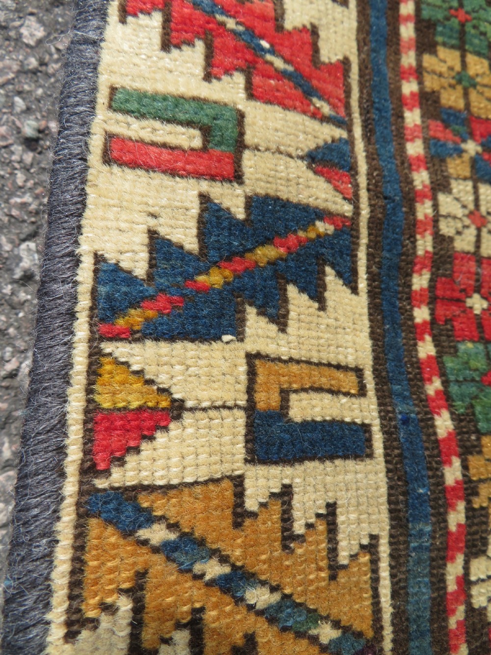 An antique Caucasian Shirvan wool runner rug with repeating geometric octagonal medallions framed by intricate multi-coloured borders. View IX
