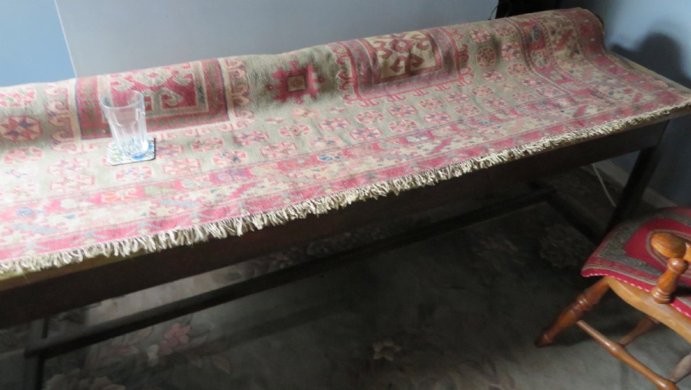 An antique Turkish Bergama wool carpet featuring a red central field surrounded by sage green areas with geometric Holbein square medallions and detailed borders. View XXIV