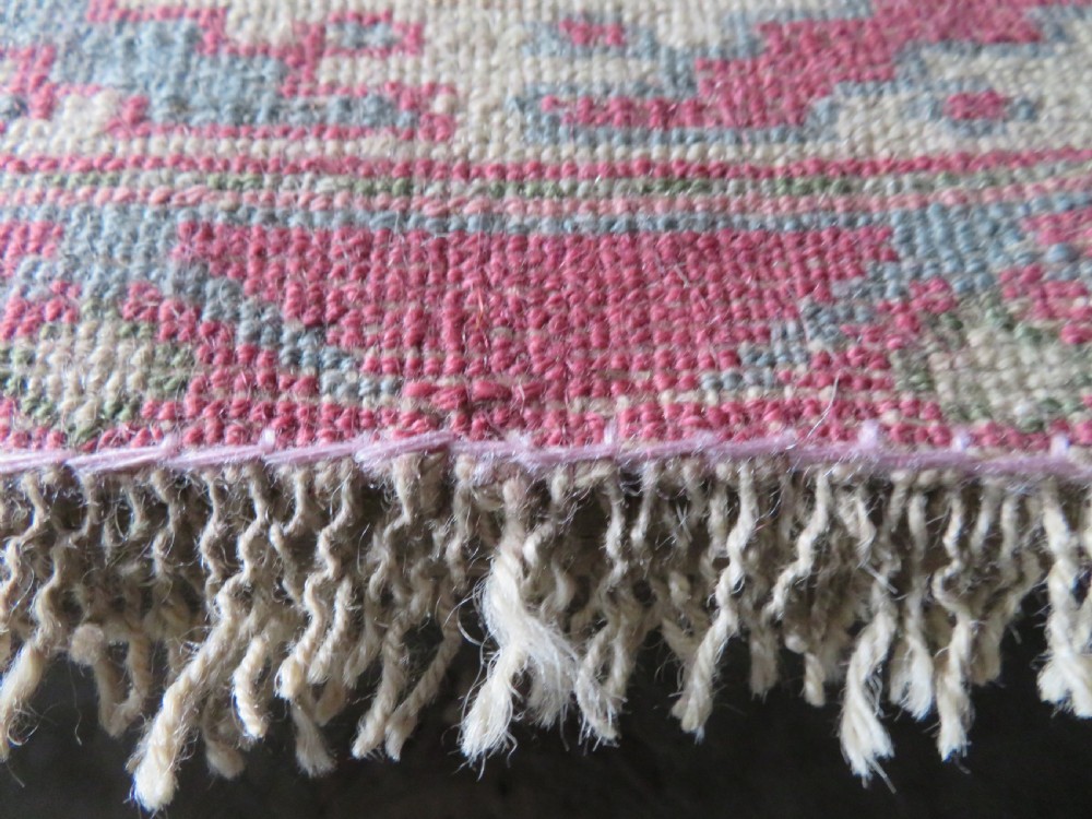 An antique Turkish Bergama wool carpet featuring a red central field surrounded by sage green areas with geometric Holbein square medallions and detailed borders. View XXV