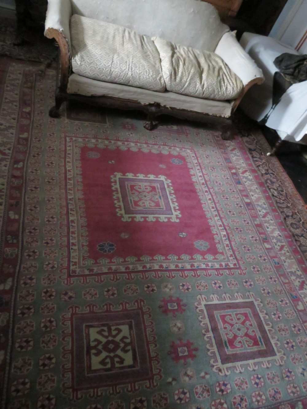 An antique Turkish Bergama wool carpet featuring a red central field surrounded by sage green areas with geometric Holbein square medallions and detailed borders. View XXVII