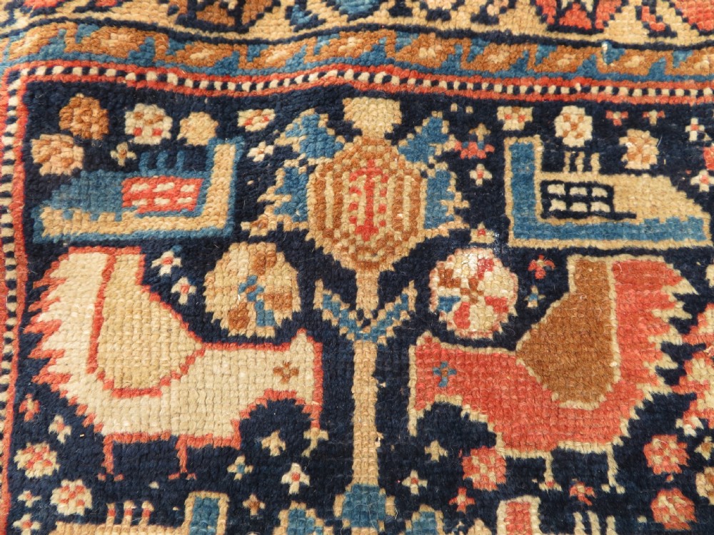 A 19th-century Khamseh hand-knotted wool bag face featuring stylised bird motifs framed by intricate geometric borders in navy blue, terracotta, and ochre. View II