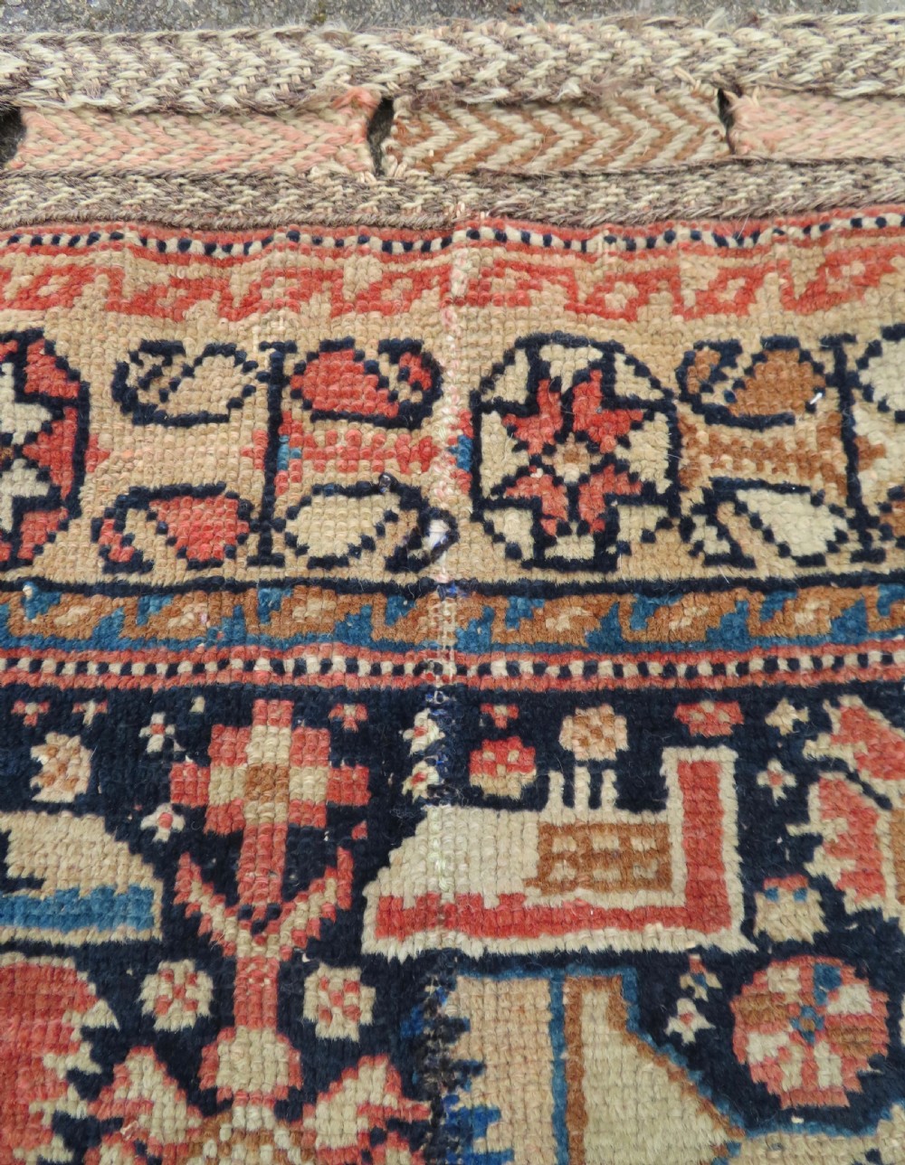 A 19th-century Khamseh hand-knotted wool bag face featuring stylised bird motifs framed by intricate geometric borders in navy blue, terracotta, and ochre. View V