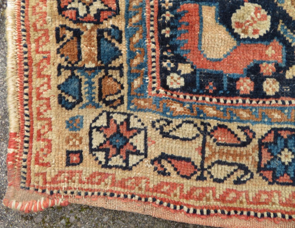 A 19th-century Khamseh hand-knotted wool bag face featuring stylised bird motifs framed by intricate geometric borders in navy blue, terracotta, and ochre. View VIII