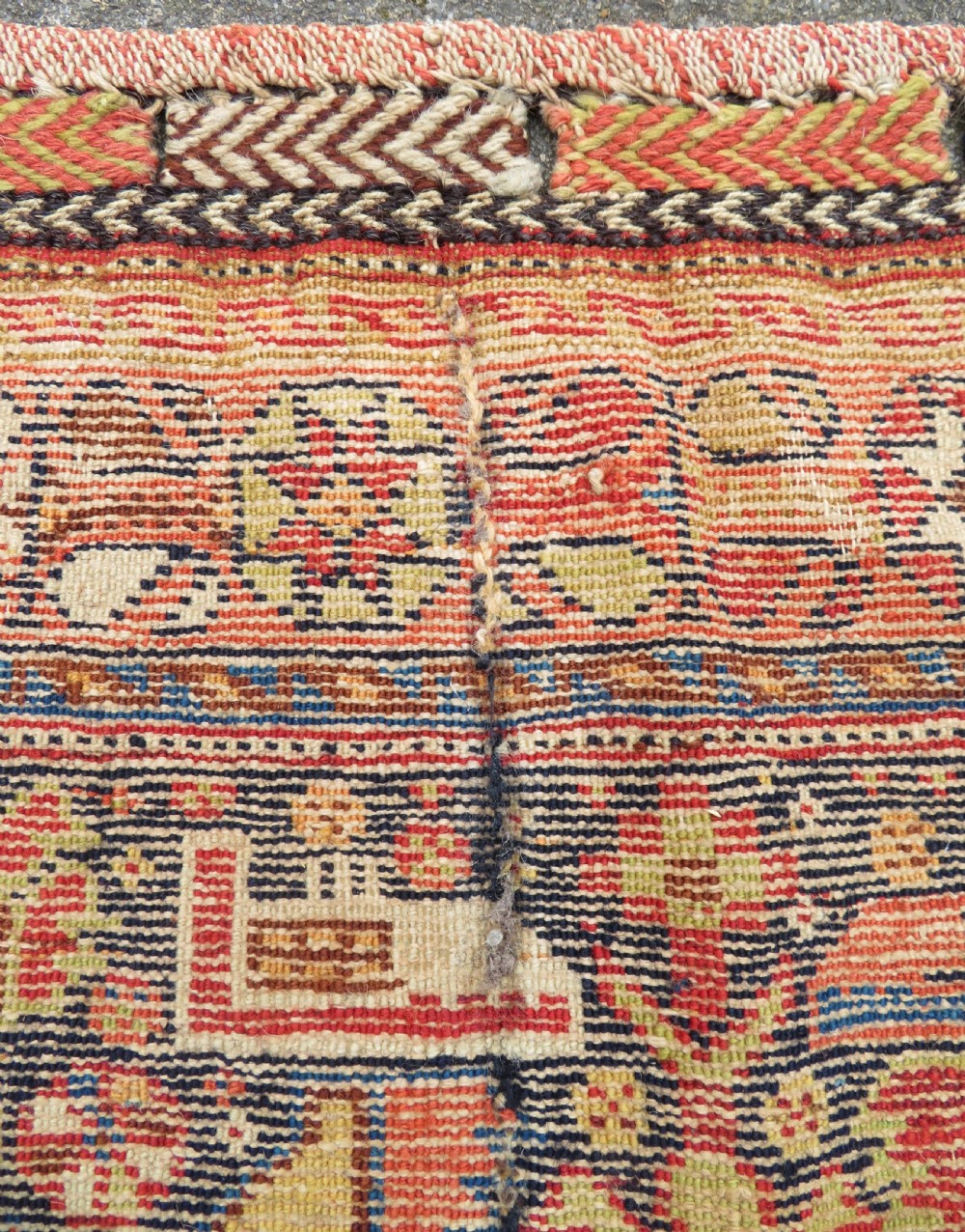 A 19th-century Khamseh hand-knotted wool bag face featuring stylised bird motifs framed by intricate geometric borders in navy blue, terracotta, and ochre. View XII
