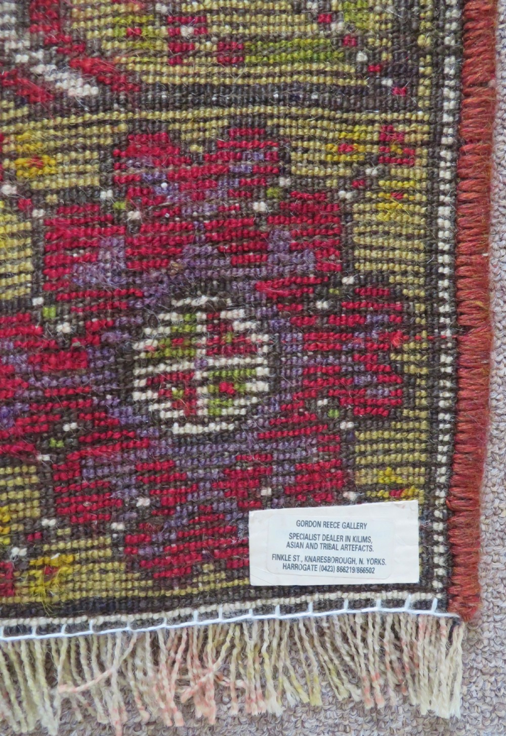 An early 19th-century Central Anatolian Konya rug featuring a central red field with a stepped diamond medallion surrounded by mustard-yellow geometric borders. View XVI
