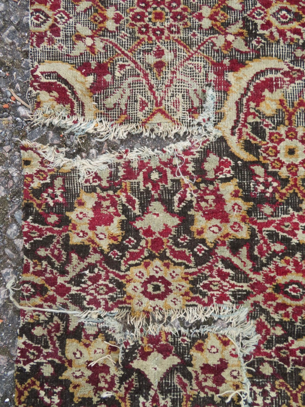 A square-shaped North Indian Mughal wool carpet fragment featuring detailed crimson and dark brown floral scrollwork. View VI