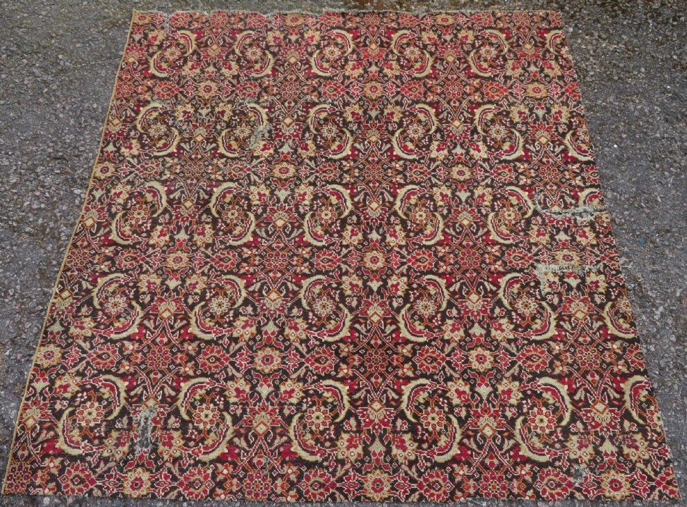 A square-shaped North Indian Mughal wool carpet fragment featuring detailed crimson and dark brown floral scrollwork. View XIII