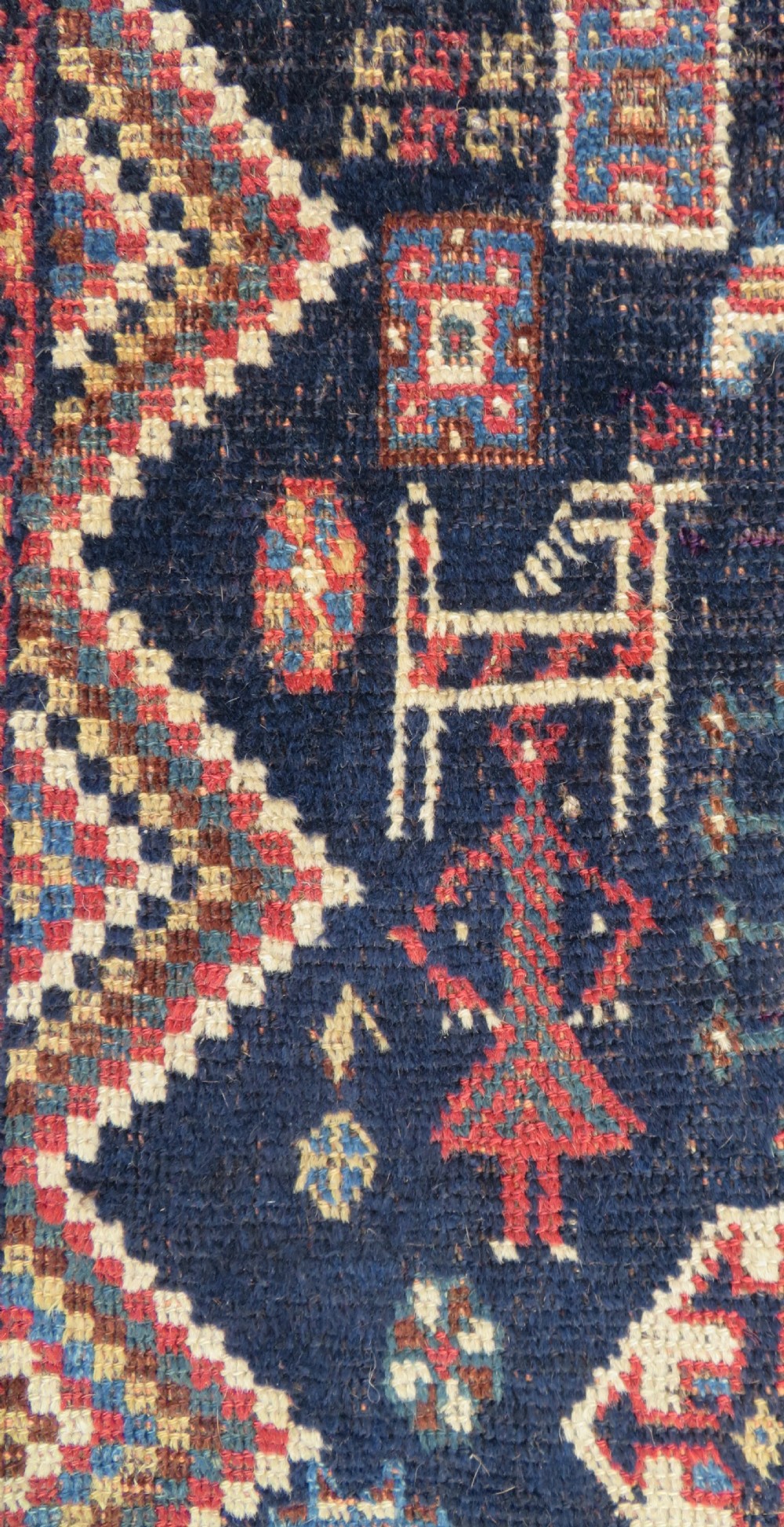 An antique hand-knotted Luri wool rug featuring three central diamond medallions surrounded by geometric tribal symbols on a dark navy field with a red border. View III