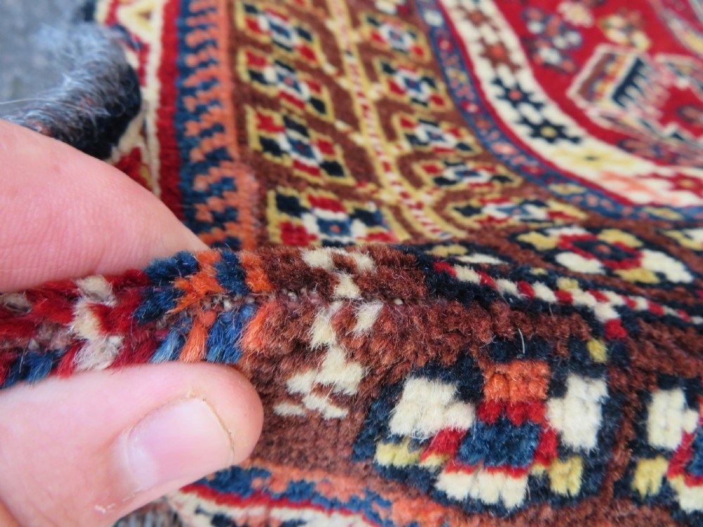 An antique Qashqai tribal wool rug featuring a deep blue central field with geometric bird motifs, red spandrels, and a complex multi-band border. View XI
