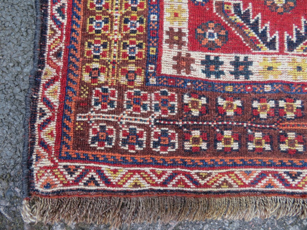An antique Qashqai tribal wool rug featuring a deep blue central field with geometric bird motifs, red spandrels, and a complex multi-band border. View XIII
