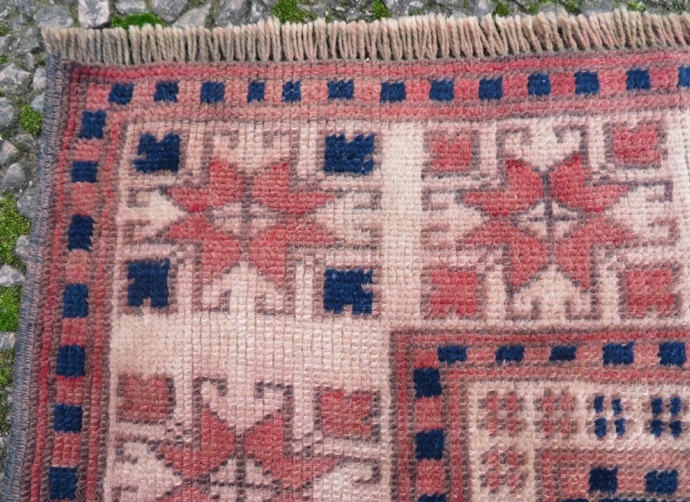 A hand-knotted wool Anatolian Bergama prayer rug featuring an ivory central field with a geometric arched mihrab design framed by terracotta and navy blue geometric borders. View IX