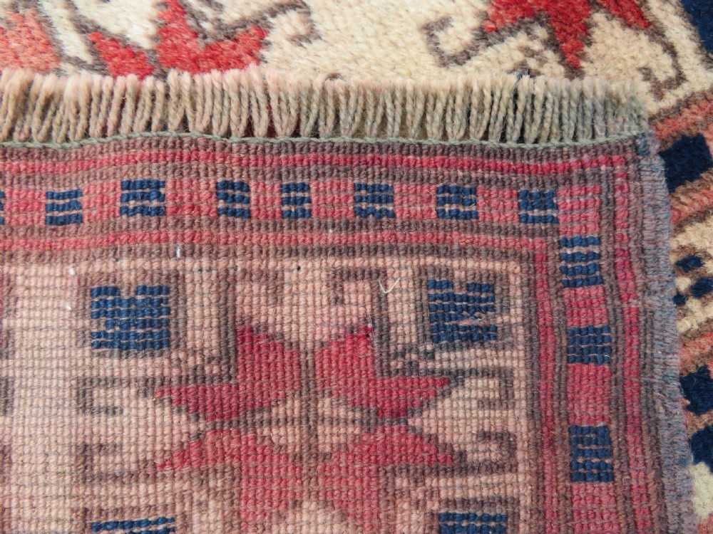 A hand-knotted wool Anatolian Bergama prayer rug featuring an ivory central field with a geometric arched mihrab design framed by terracotta and navy blue geometric borders. View XI