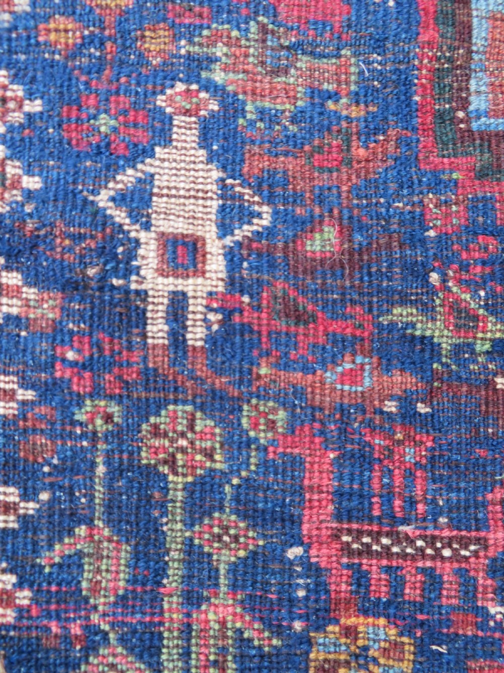 An antique Persian Khamseh rug featuring three central diamond medallions surrounded by small animal motifs and a geometric border in indigo blue and terracotta red tones. View XIII