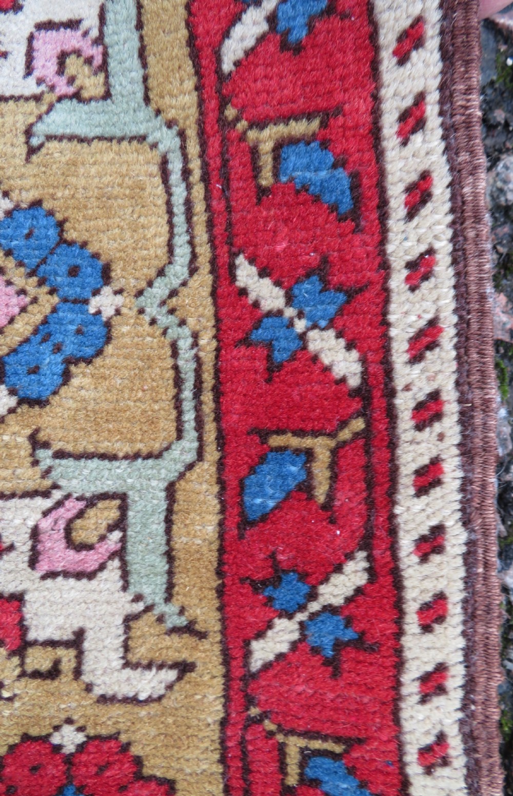 A mid-19th-century hand-knotted Turkish Ladik prayer rug featuring a blue central niche on a red ground with inverted tulip motifs and a patterned yellow border. View VII