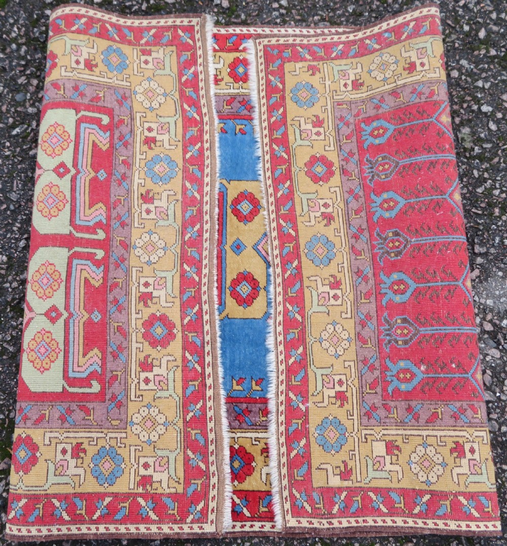 A mid-19th-century hand-knotted Turkish Ladik prayer rug featuring a blue central niche on a red ground with inverted tulip motifs and a patterned yellow border. View X