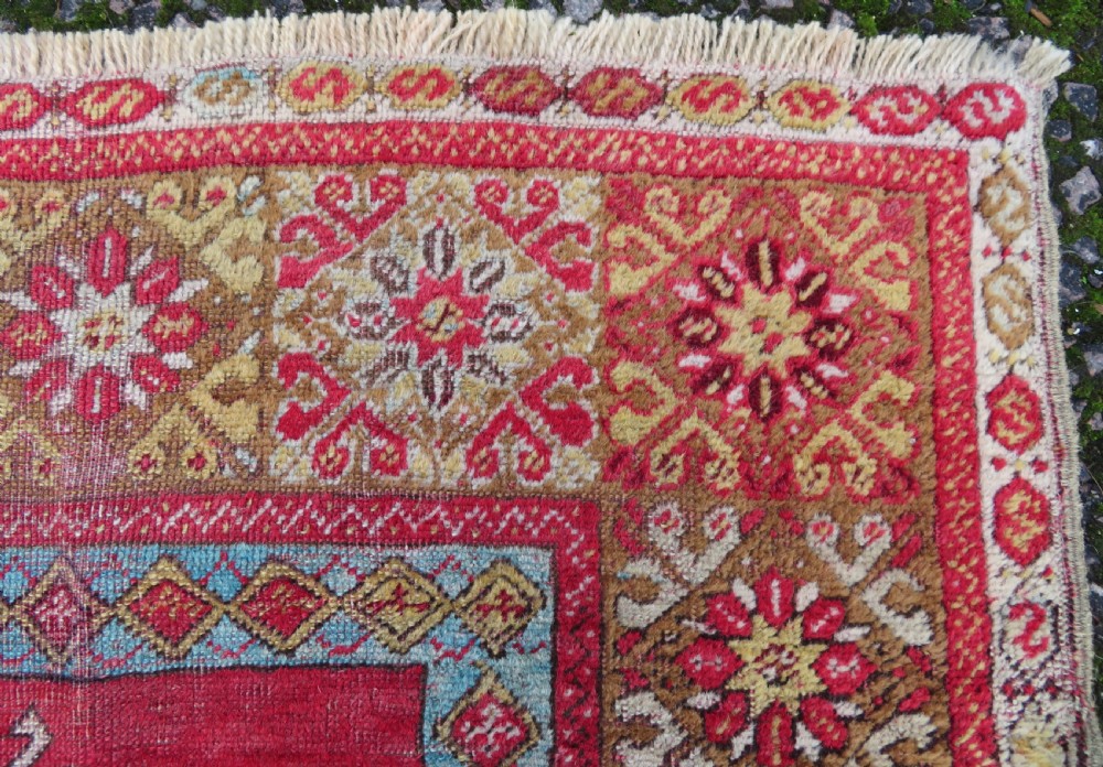 A mid-19th-century hand-knotted Turkish Mudjur prayer rug with a red central mihrab niche framed by geometric floral patterned borders. View VI
