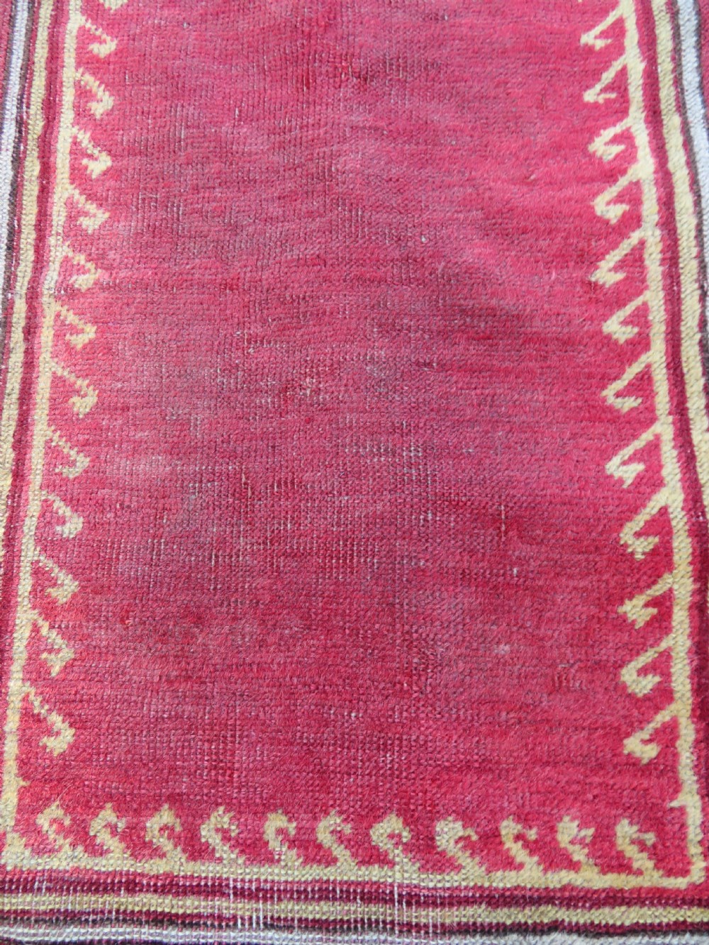 A mid-19th-century hand-knotted Turkish Mudjur prayer rug with a red central mihrab niche framed by geometric floral patterned borders. View VIII