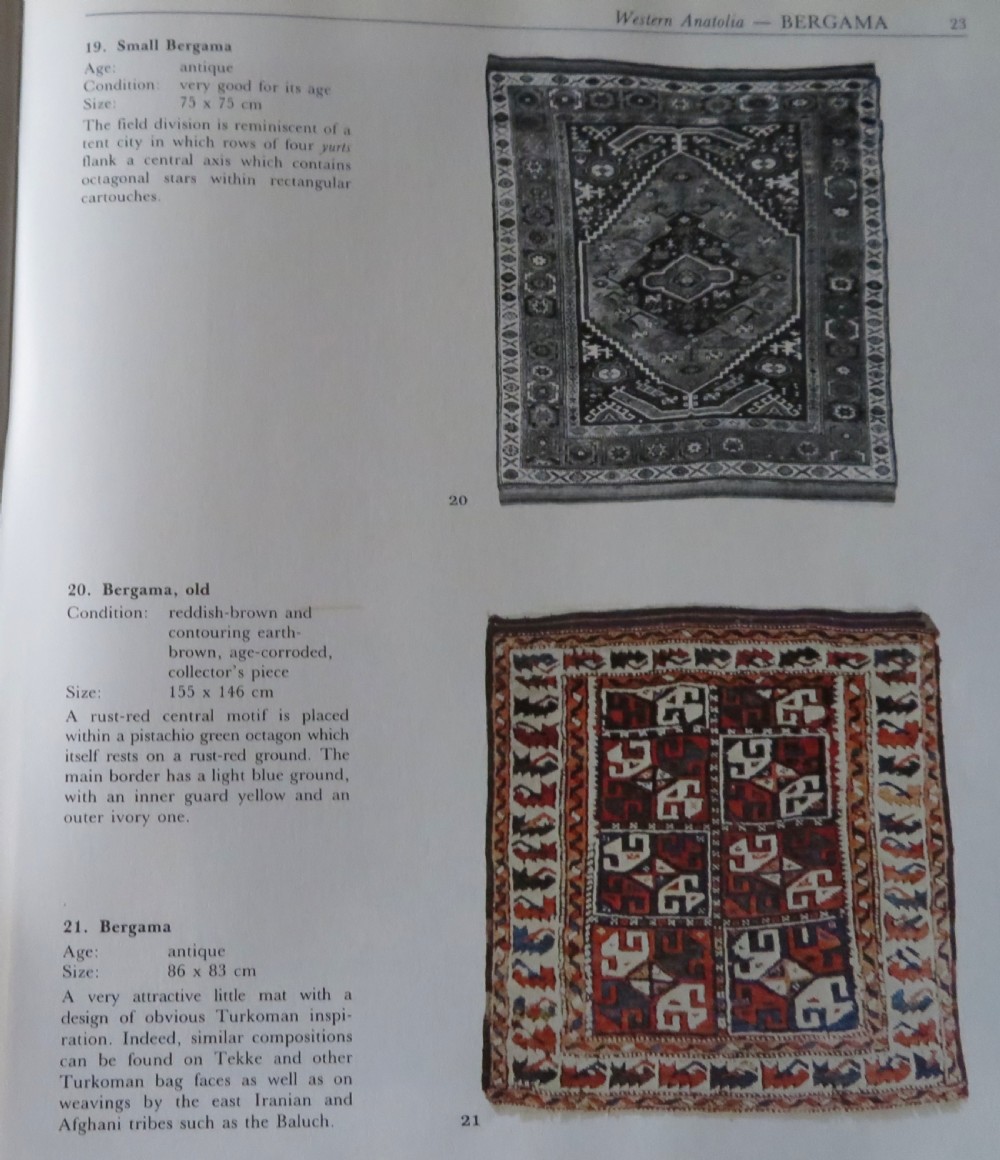 A small antique Turkish Bergama wool rug featuring a deep red central field with repeating floral-like motifs surrounded by geometric cream and blue borders. View XI