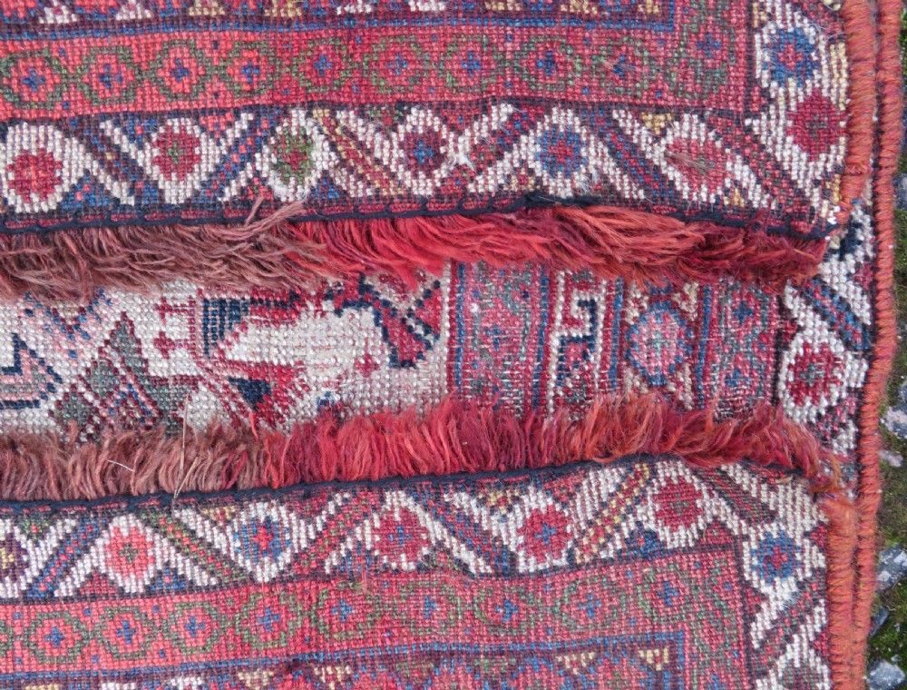 An antique hand-knotted Khamseh tribal kelleh carpet with a dark red field, geometric diamond medallions, and small bird motifs. View XXIII