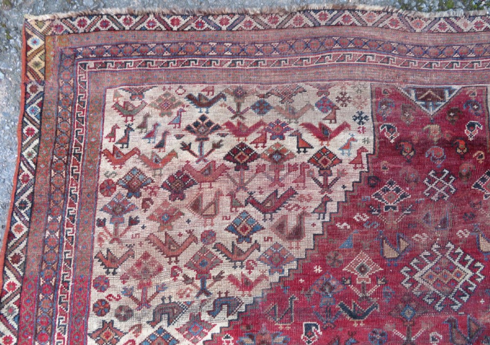 A long hand-knotted antique Persian Khamseh carpet featuring geometric diamond medallions and intricate tribal motifs in red, blue, and cream tones. View XIII